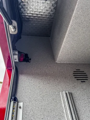 Lower slide-out tray pulled from side compartment with textured tray surface.